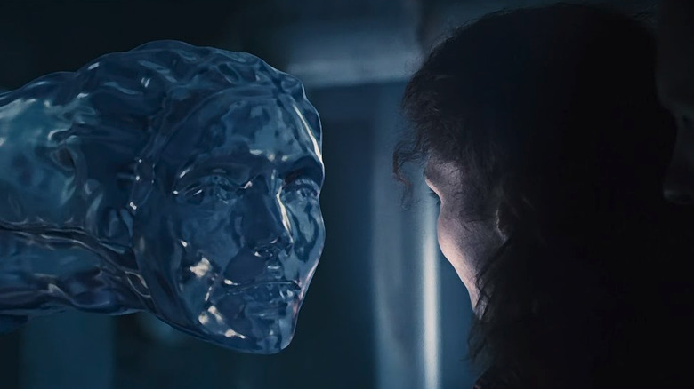 Dr. Lindsey Brigman (Mary Elizabeth Mastrantonio) looking at a water version of her face in The Abyss