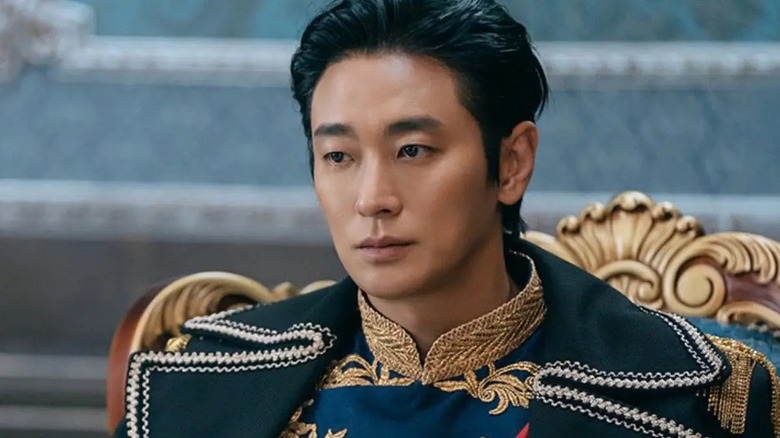 Sovieshu (Ju Ji-hoon) sits stoically in a decorated coat in The Remarried Empress