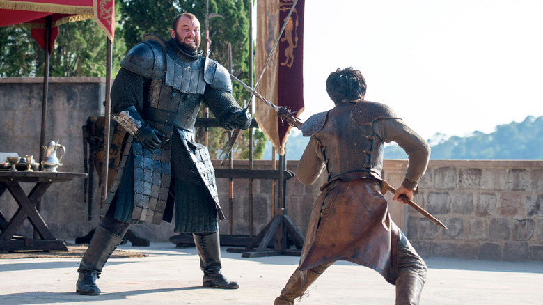 An armored Gregor Clegane (Hafþór Júlíus Björnsson) advances on a spear-wielding Oberyn Martell (Pedro Pascal) in Game of Thrones