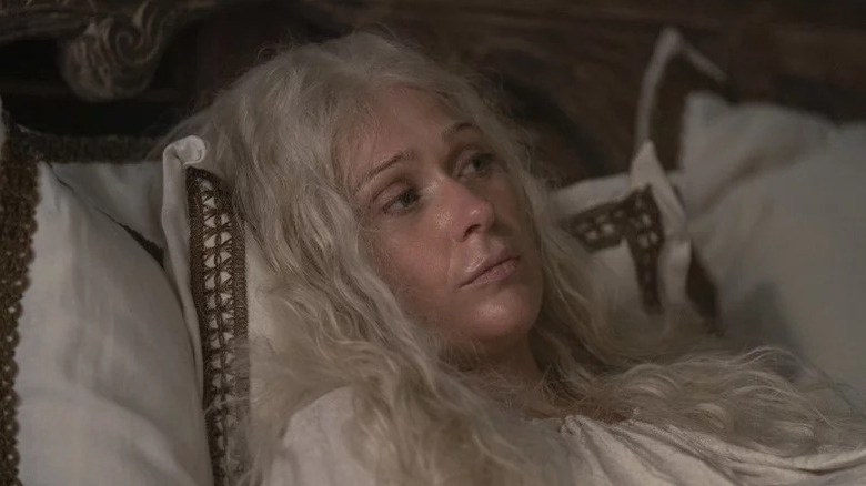 Queen Aemma Arryn (Siân Brooke) lays disheveled in a bed in House of the Dragon