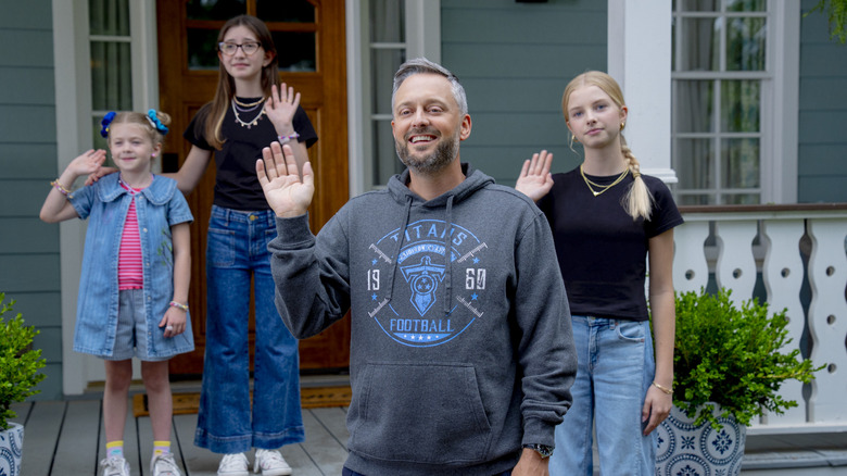 Nate Bargatze as Nate Wilcox in The Bradwinner, surrounded by Stella Grace Fitzgerald as Gracie, Charlotte Ann Tucker as Sam, and  Birdie Borria as Hadley, all waving from the porch of a house.