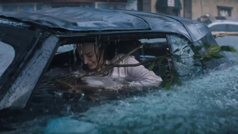 Phoebe Dynevor as Lisa in Thrash, stuck underneath piles of branches in a submerged car.