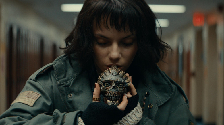 Dafne Keen as Chrys Willet in Whistle, blowing into the Aztec whistle.