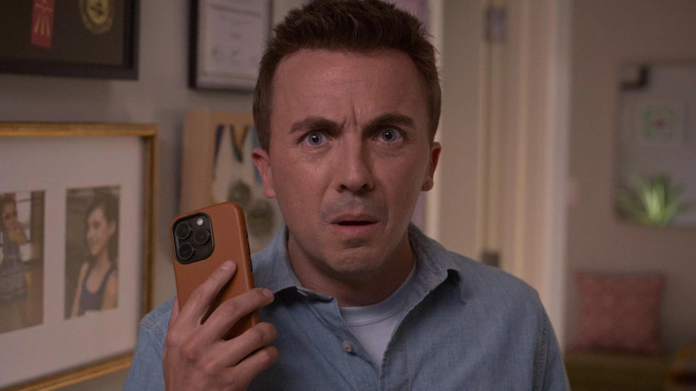 Frankie Muniz as Malcom holding his phone in Malcolm in the Middle: Life's Still Unfair