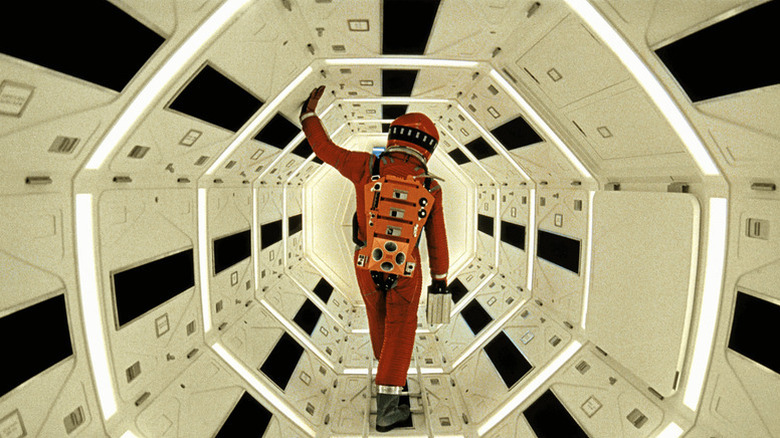 David Bowman (Keir Dullea) walks through a lit tunnel while wearing a spacesuit in 2001: A Space Odyssey