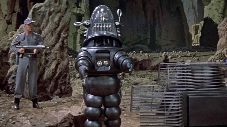 A guard watches over Robbie the Robot in Forbidden Planet
