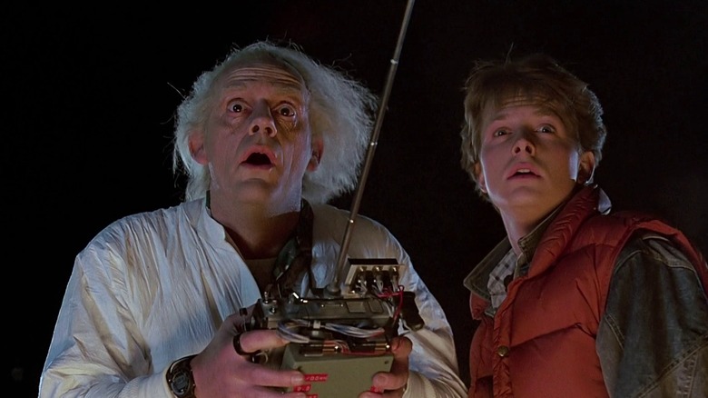 Doc Brown (Christopher Lloyd) holding a controller with Marty (Michael J. Fox) in Back to the Future