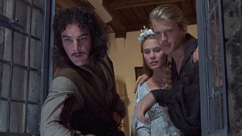 Westley (Cary Elwes), Princess Buttercup (Robin Wright), and Inigo Montoya (Mandy Patinkin) look out a window in The Princess Bride