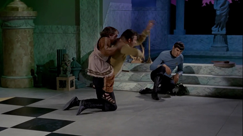 Alexander (Michael Dunn) rides James T. Kirk's (William Shatner) back as Spock (Leonard Nimoy) reclines nearby in Star Trek: The Original Series