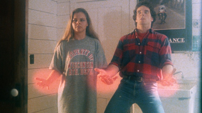 Dana Day as Dolly and James Fitzgibbons as Ted, fighting a psychic battle in Blood Beat