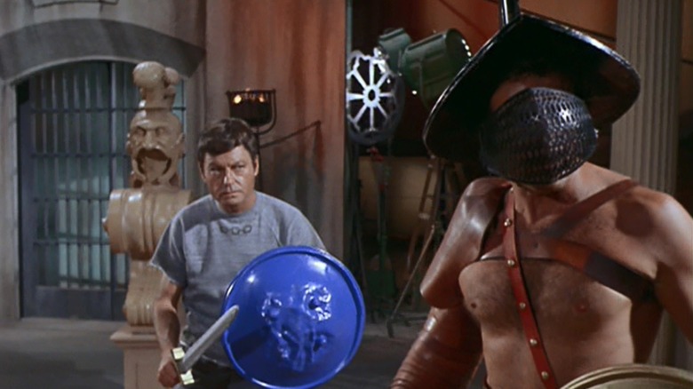 McCoy (DeForest Kelley) faces a Roman gladiator on a television set in Star Trek: The Original Series