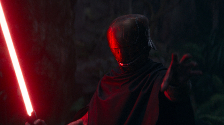 Qimir (Manny Jacinto) wielding a red lightsaber on The Acolyte