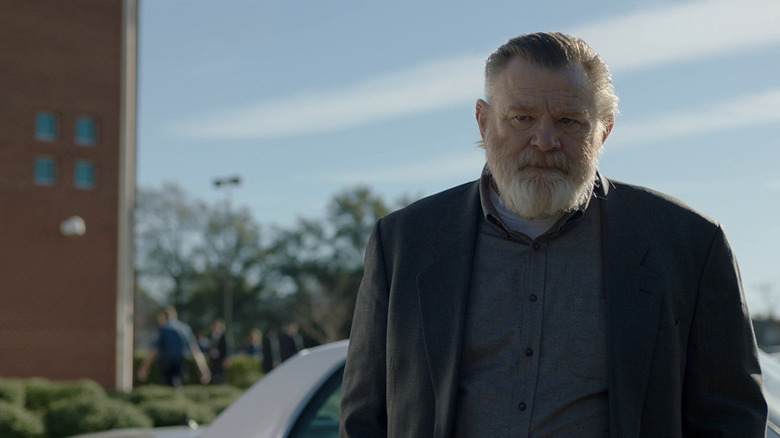 Bill Hodges (Brendan Gleeson) stands outside in the sunset in Mr. Mercedes