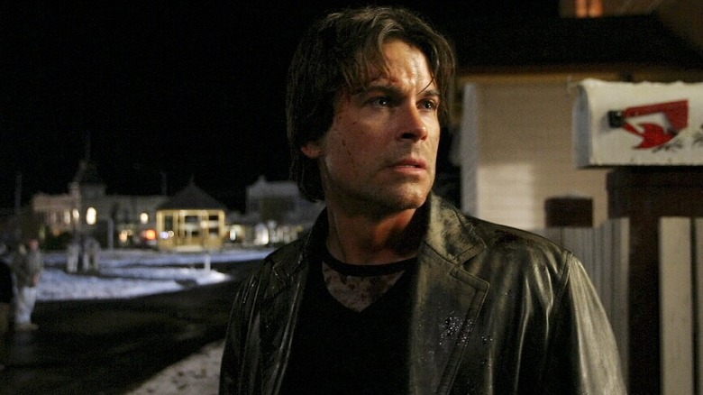 Ben Mears (Rob Lowe) stands on a snowy street at night in Salem's Lot (2004)