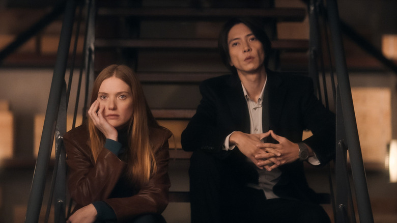 Camille Léger (Fleur Geffrier) and Issei Tomine (Tomohisa Yamashita) sit on stairs in Drops of God