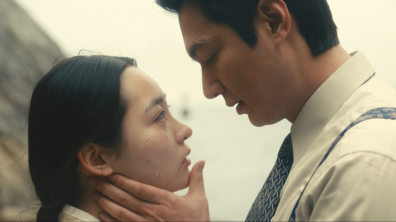 Koh Hansu (Lee Min-ho) leads in to kiss a crying Kim Sunja (Kim Min-ha) in Pachinko