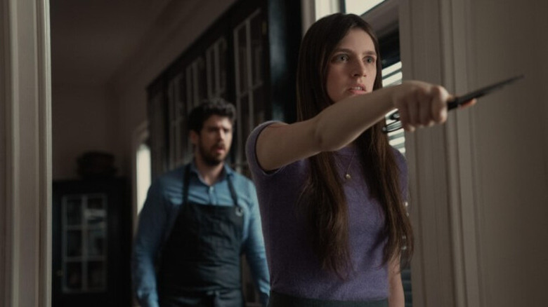 Leanne (Nell Tiger Free) menacingly points with a pair of scissors in Servant