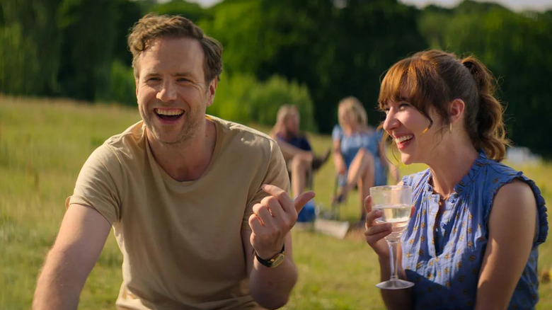 Jason Ross (Rafe Spall) laughs with Nikki Newman (Esther Smith) on a sunny hill in Trying