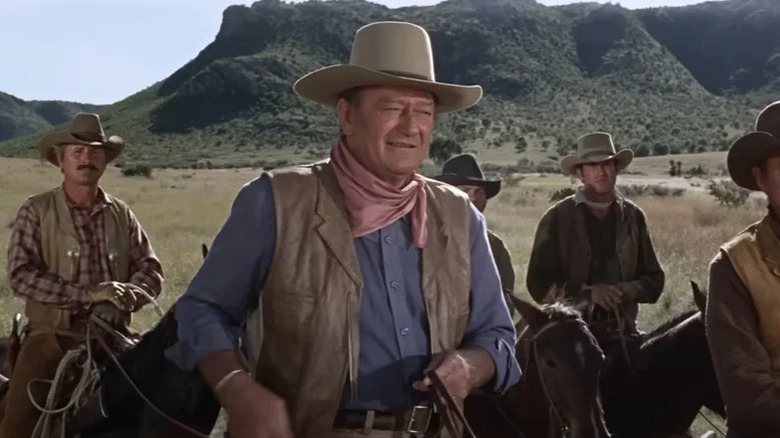 John Chisum (John Wayne) rides with a group of ranchers in Chisum
