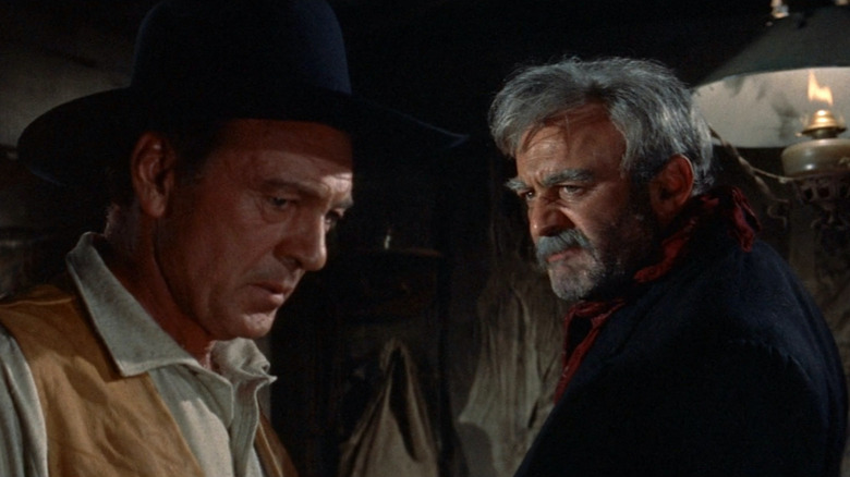 Dock Tobin (Lee J. Cobb) looks at a troubled Link Jones (Gary Cooper) in Man of the West
