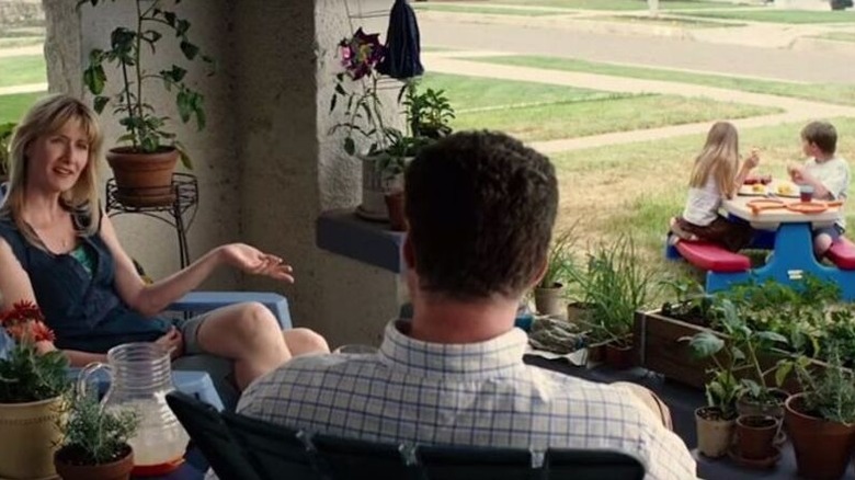 Delilah (Laura Dern) speaks with Nick Halsey (Will Ferrell) as her children sit in the front yard in Everything Must Go