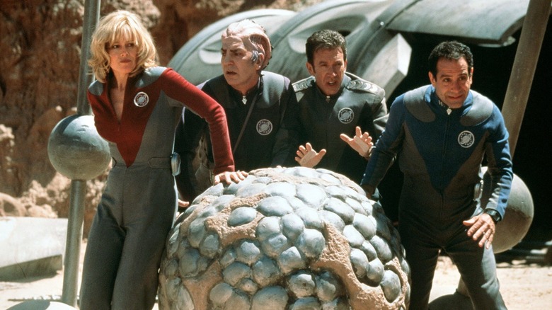 Gwen DeMarco (Sigourney Weaver), Alexander Dane (Alan Rickman), Jason Nesmith (Tim Allen), and Fred Kwan (Tony Shalhoub) roll a berillium sphere on the surface of an alien planet in Galaxy Quest
