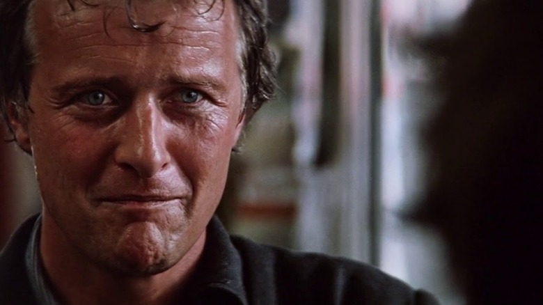 Rutger Hauer as John Ryder, toying with his food in The Hitcher