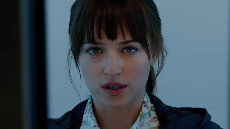 Ana Steele (Dakota Johnson) in an elevator with the doors closing in Fifty Shades of Grey