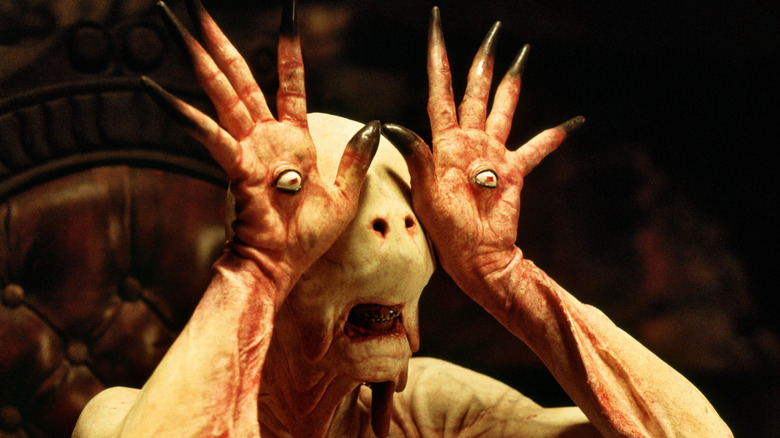The Pale Man raises hands