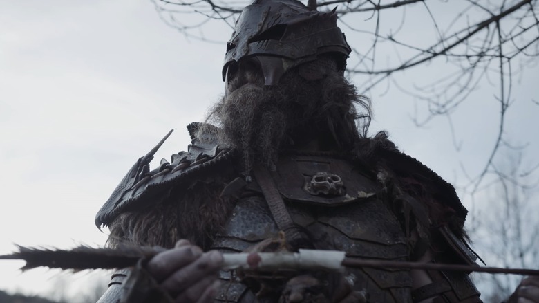 The Head Hunter holds arrow