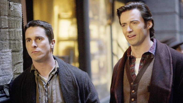 Christian Bale and Hugh Jackman as Alfred Borden and Robert Angier in The Prestige