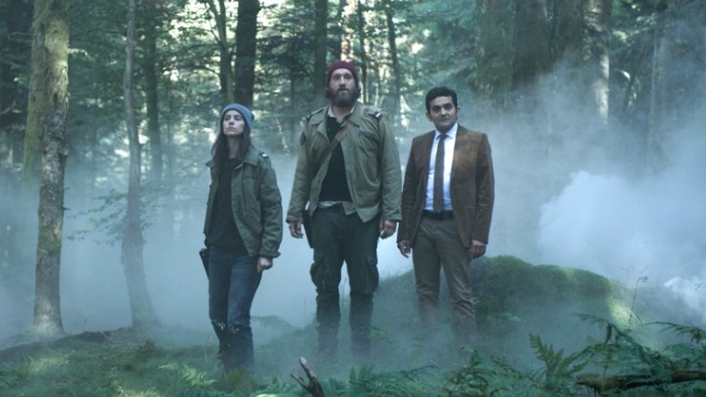 Black Spot Major Laurène Weiss, Martial Ferrandis, and Prosecutor Franck Siriani standing misty forest