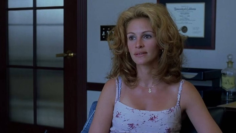 Erin Brokovich (Julia Roberts) sitting in an office