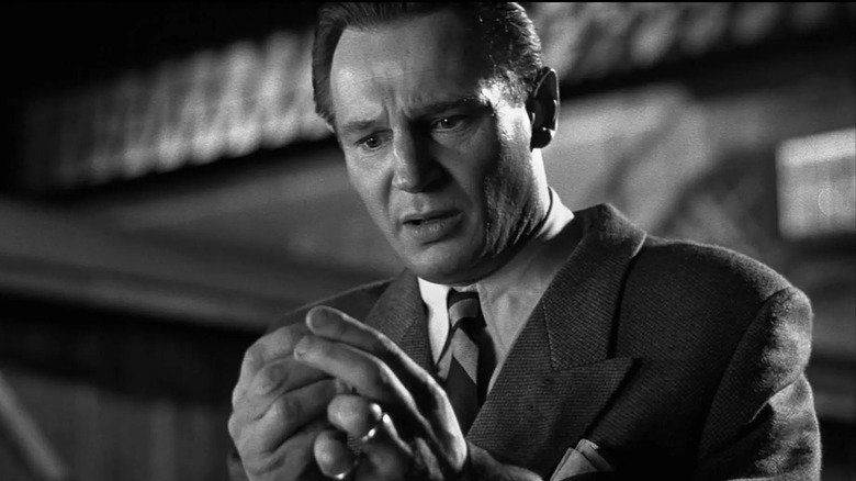 Oskar Schindler (Liam Neeson) looking at his hands in Schindler's List