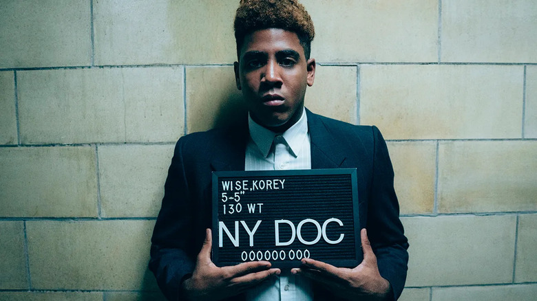 Jharrel Jerome as Korey Wise, standing for a mugshot, in When They See Us