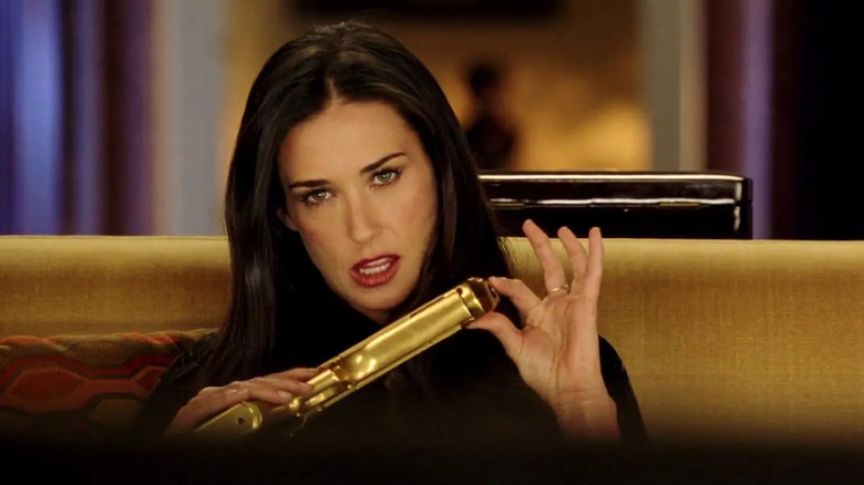 Demi Moore as Madison Lee seductively holding a gold gun in Charlie's Angels: Full Throttle