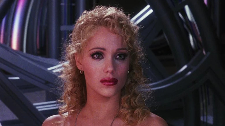 Elizabeth Berkley as Nomi in full makeup looking sad in Showgirls