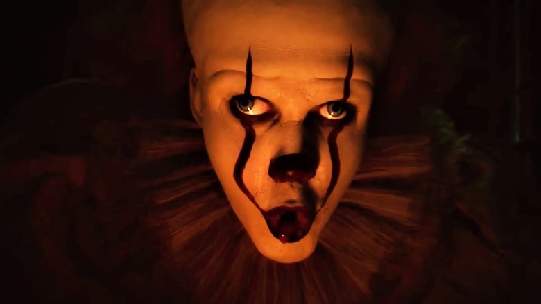 Pennywise (Bill Skarsgard) lures Vicky under the bleachers in It Chapter Two