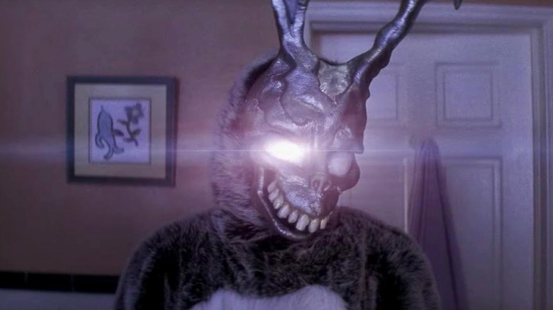 James Duval as Frank in Donnie Darko, in his iconic bunny costume, facing the camera as his right eye starts to glow with light.