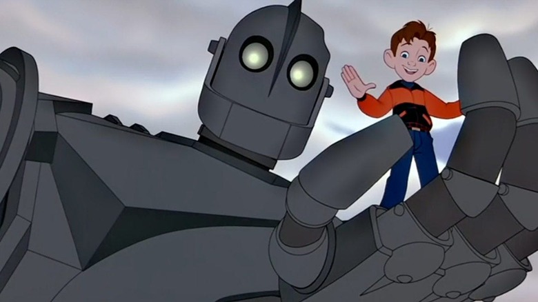 Vin Diesel as The Iron Giant, holding Eli Marienthal as Hogarth Hughes in his giant hand.