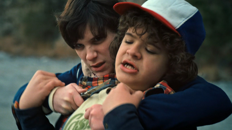 Troy (Peyton Wich) holding a knife to Dustin (Gaten Matarazzo) on Stranger Things