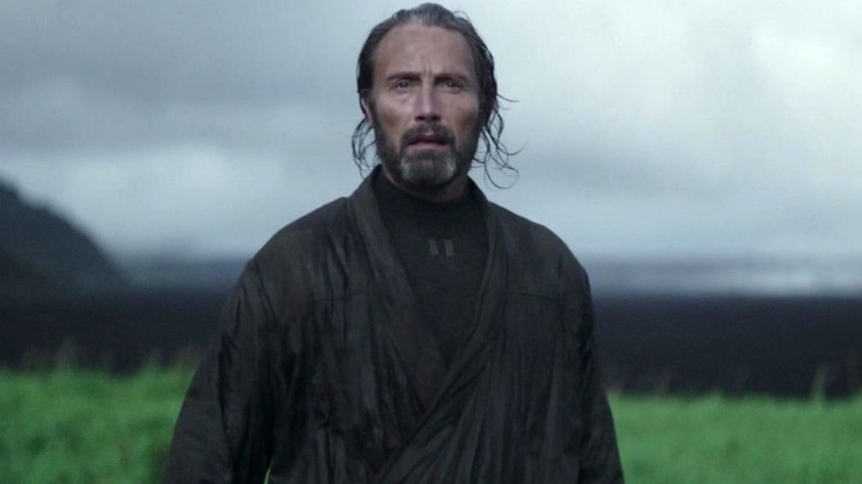 Galen Erso (Mads Mikkelsen) stands in a field in Rogue One: A Star Wars Story