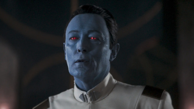 Thrawn (Lars Mikkelsen) stands smirking in front of Stormtroopers in Ahsoka