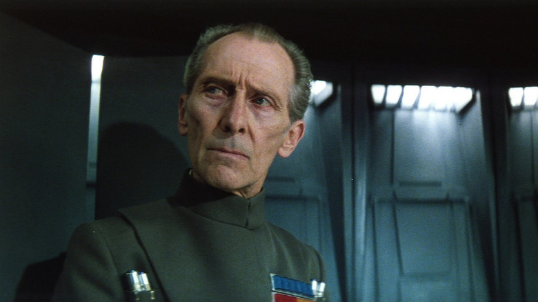 Tarkin (Peter Cushing) glances to his right in A New Hope