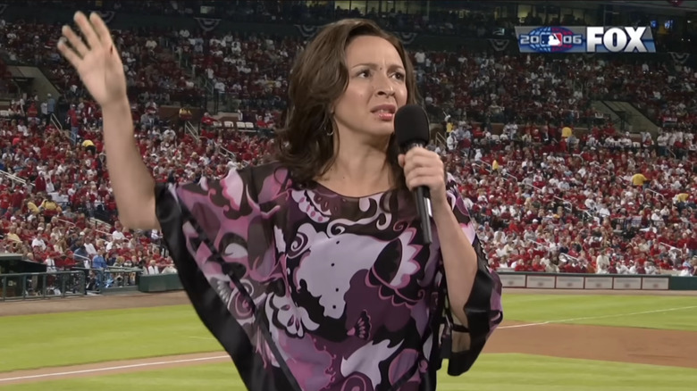 Maya Rudolph singing the National Anthem in front of a football stadium in an SNL sketch