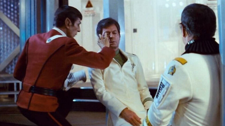 Spock (Leonard Nimoy) mind melds with an unconscious McCoy (DeForest Kelley) in Star Trek II: The Wrath of Khan