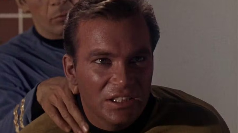 Spock (Leonard Nimoy) nerve pinches a maddened Kirk (William Shatner) from behind in Star Trek: The Original Series