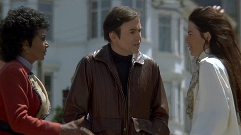 Uhura (Nichelle Nichols) and Chekov (Walter Koenig) speak with a confused pedestrian (Layla Sarakalo) in Star Trek IV: The Voyage Home