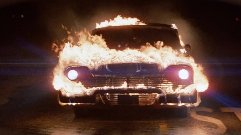 A flaming Plymouth Fury drives down the road in Christine