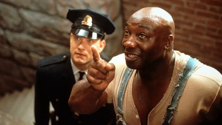 John Coffey (Michael Clarke Duncan) points up next to Paul Edgecomb (Tom Hanks) in The Green Mile